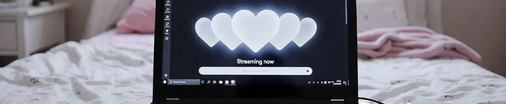Laptop with heart icons and streaming setup